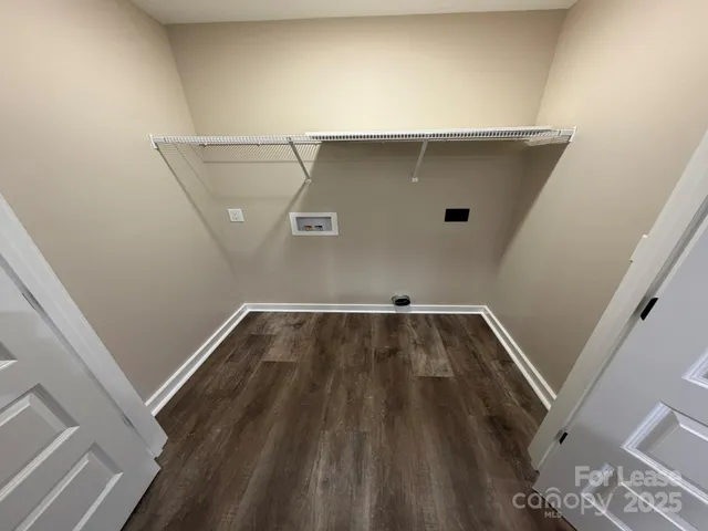 a view of a hallway with wooden floor and closet