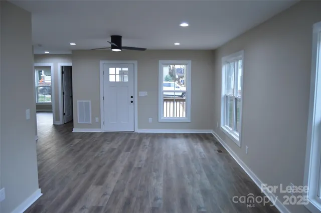 a view of a small space with wooden floor and a window