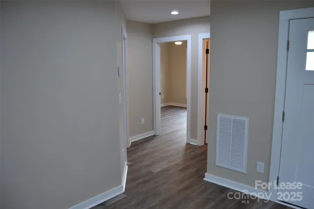 a view of hallway with wooden floor