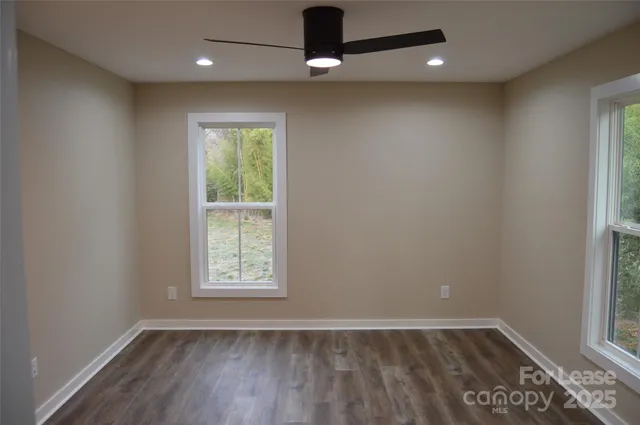 a view of a room with wooden floor and fan