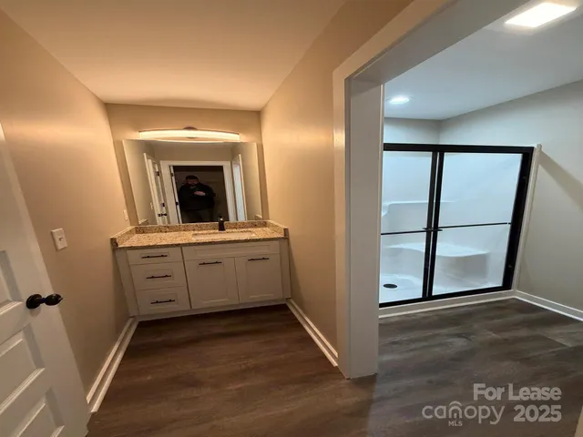 a bathroom with a toilet and a mirror