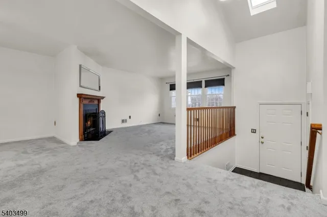 a view of empty room with a fireplace
