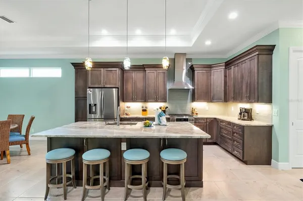 a kitchen with granite countertop a sink cabinets and stove