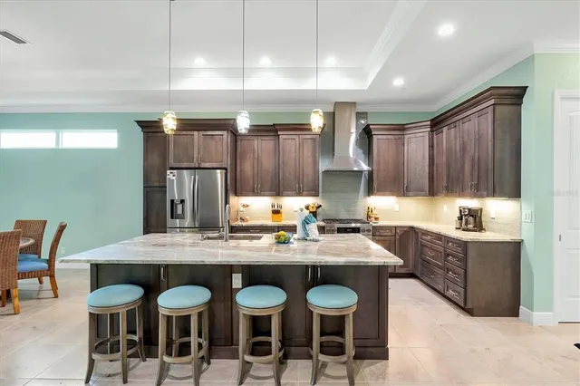 a kitchen with granite countertop a sink cabinets and stove
