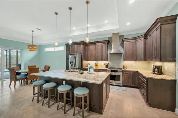 a kitchen with a stove a sink a table and chairs
