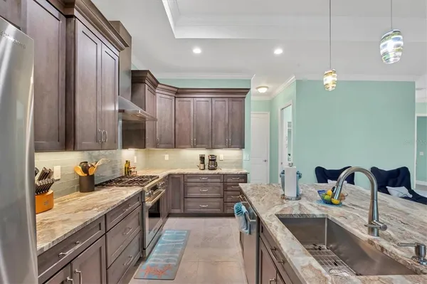 a kitchen with a sink stove and cabinets