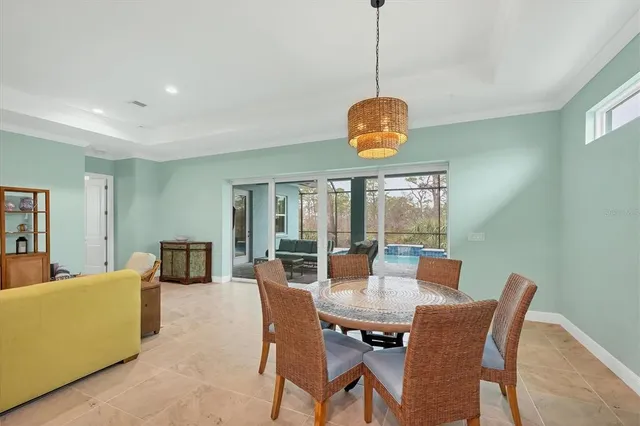 a view of a dining room with furniture wooden floor and chandelier
