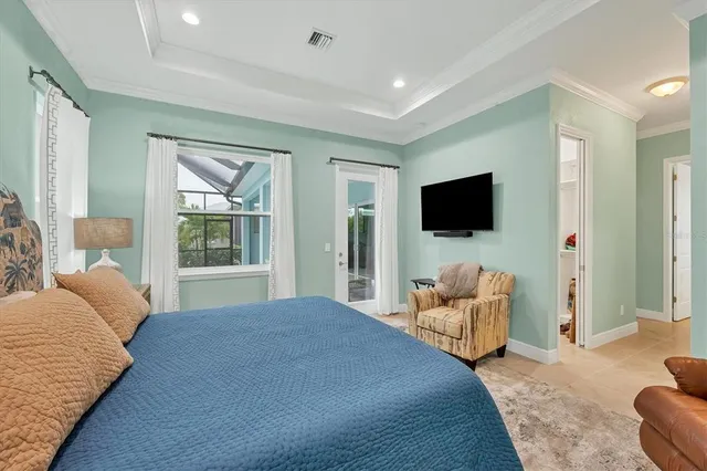 a bedroom with a bed and glass windows