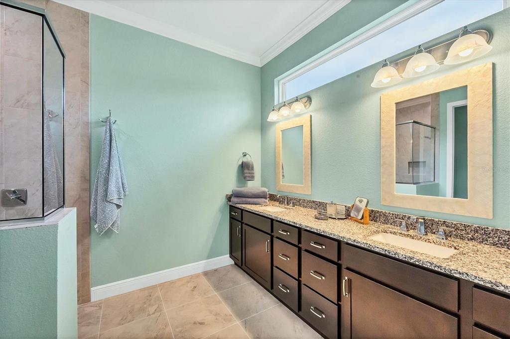 8936 Scallop Way Placida, FL 33946 - Photo 23 of 46 a bathroom with a granite countertop sink and a mirror