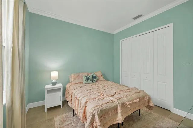 a bedroom with a bed and a wall painting