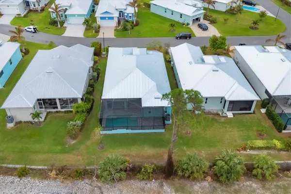 an aerial view of a house with a yard