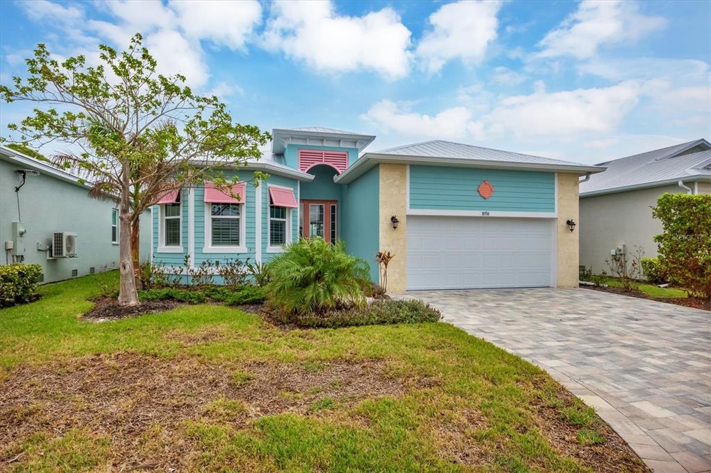 8936 Scallop Way Placida, FL 33946 - Photo 5 of 46 a front view of a house with a yard and garage