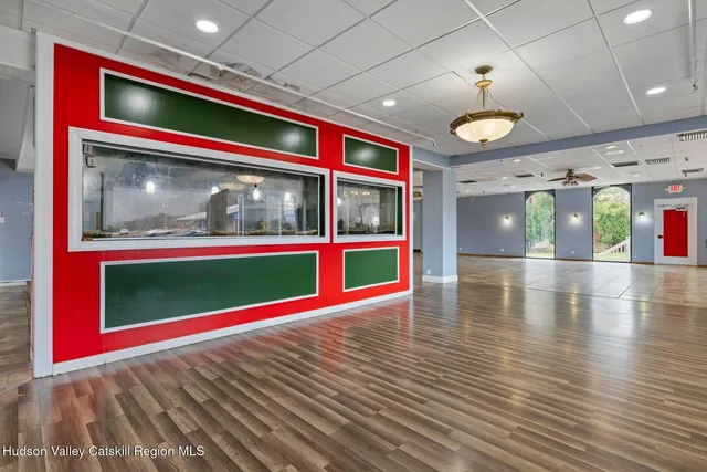 a view of a hall with a dining table chairs and entryway