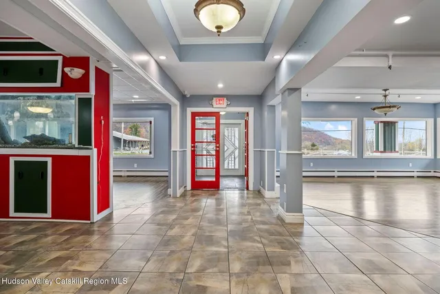 a living room with lots of furniture and a kitchen view
