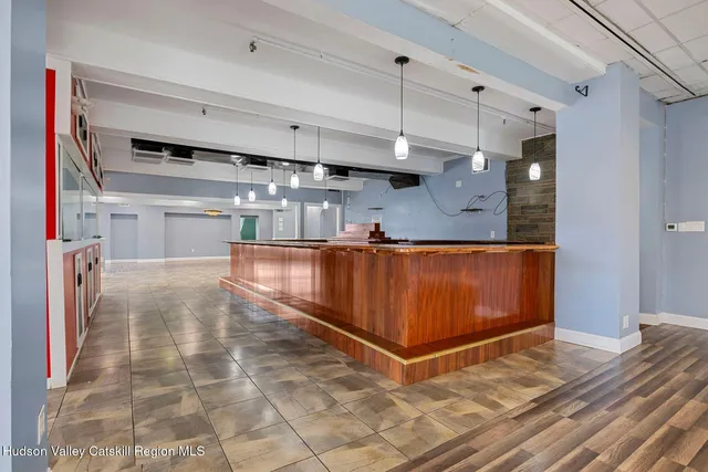 a kitchen with stainless steel appliances granite countertop a stove a refrigerator and a table