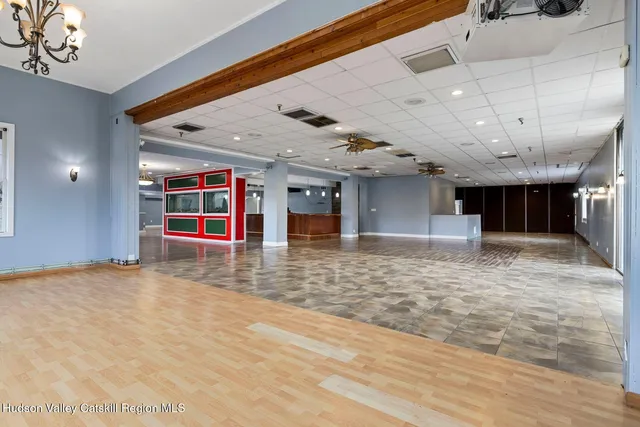a kitchen with stainless steel appliances granite countertop a stove and a view of living room