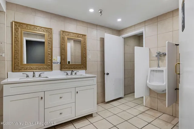 a kitchen with stainless steel appliances granite countertop a sink and a refrigerator