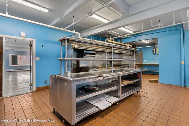 a room with a table chairs and wooden floor