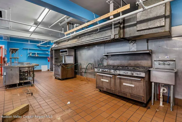 a view of a livingroom with wooden floor and a ceiling fan