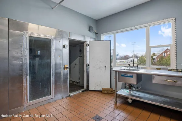 a view of a hallway with wooden floor and glass door