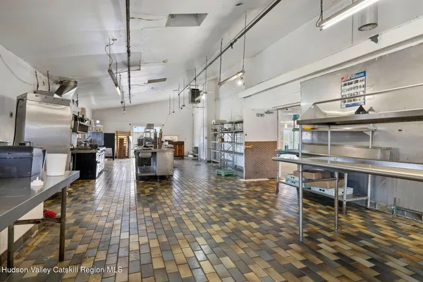 a bathroom with a granite countertop sink and a window