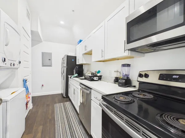a kitchen with a stove and a refrigerator