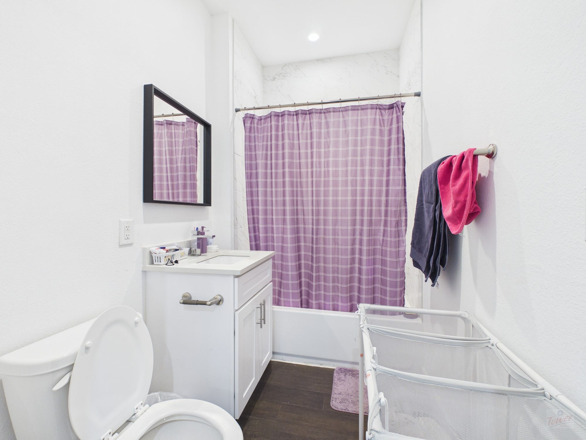 1010 West 26th Street, Unit 503 Austin, TX 78705 - Photo 6 of 6 a bathroom with a toilet sink vanity tub and mirror