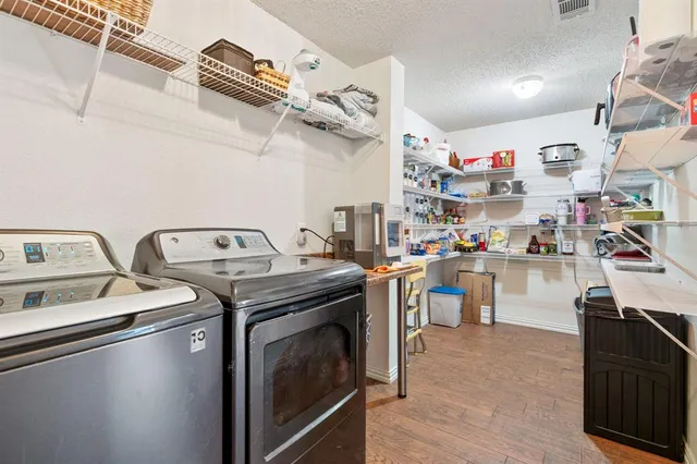 a kitchen with appliances cabinets and a table
