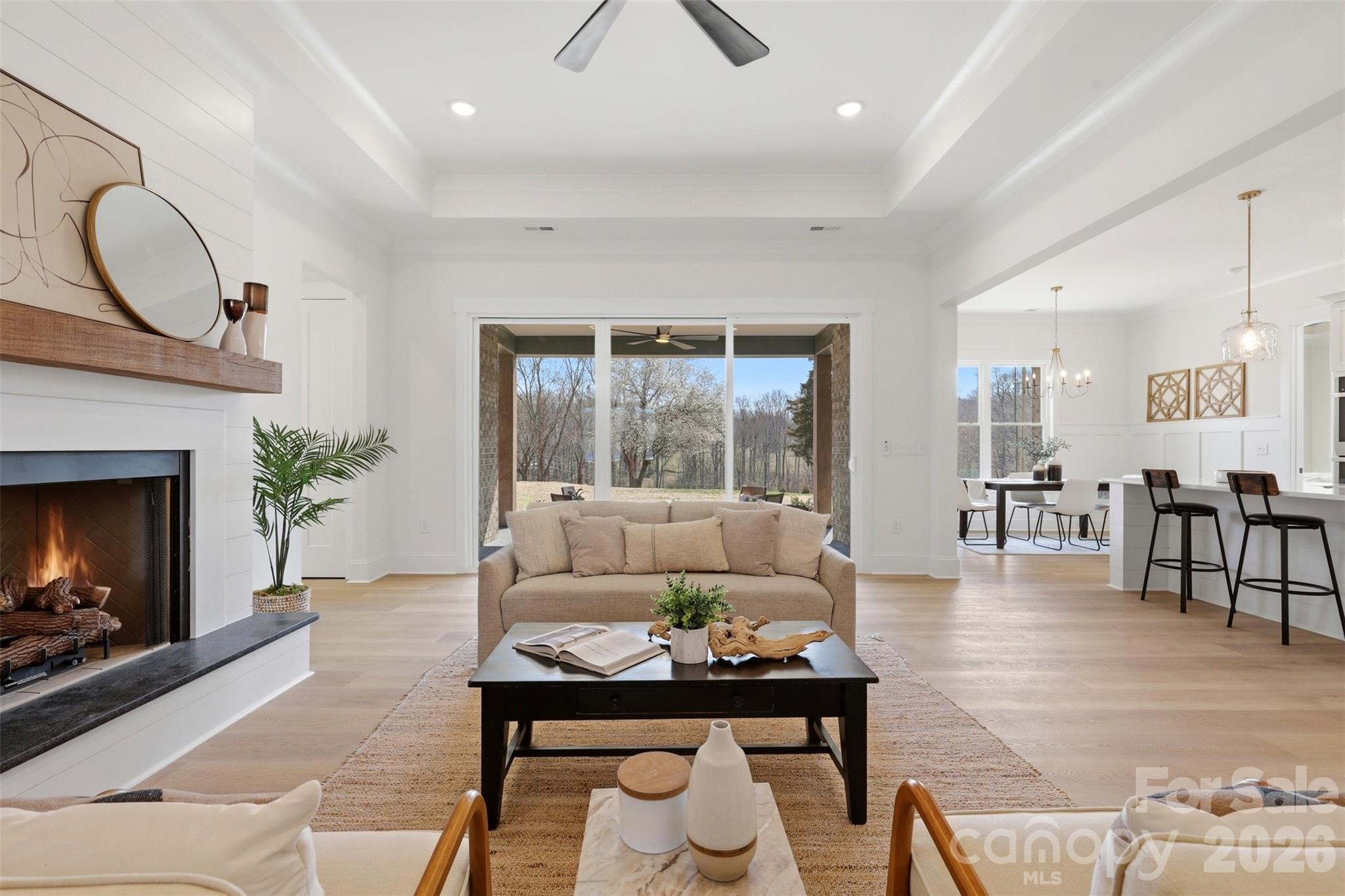 4748 Polk Ford Road Stanfield, NC 28163 - Photo 12 of 47 a living room with furniture a fireplace a rug and a large window