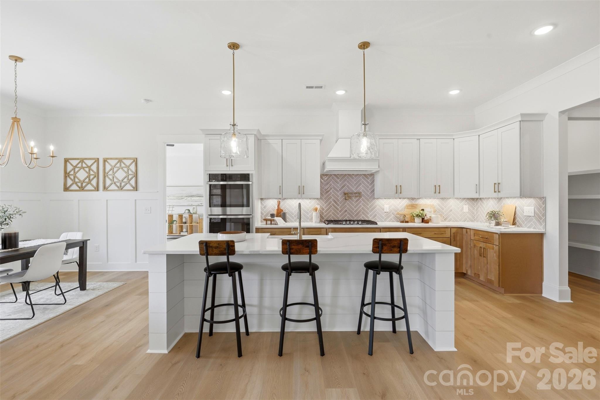 4748 Polk Ford Road Stanfield, NC 28163 - Photo 13 of 47 a kitchen with stainless steel appliances kitchen island granite countertop a wooden floor and white cabinets