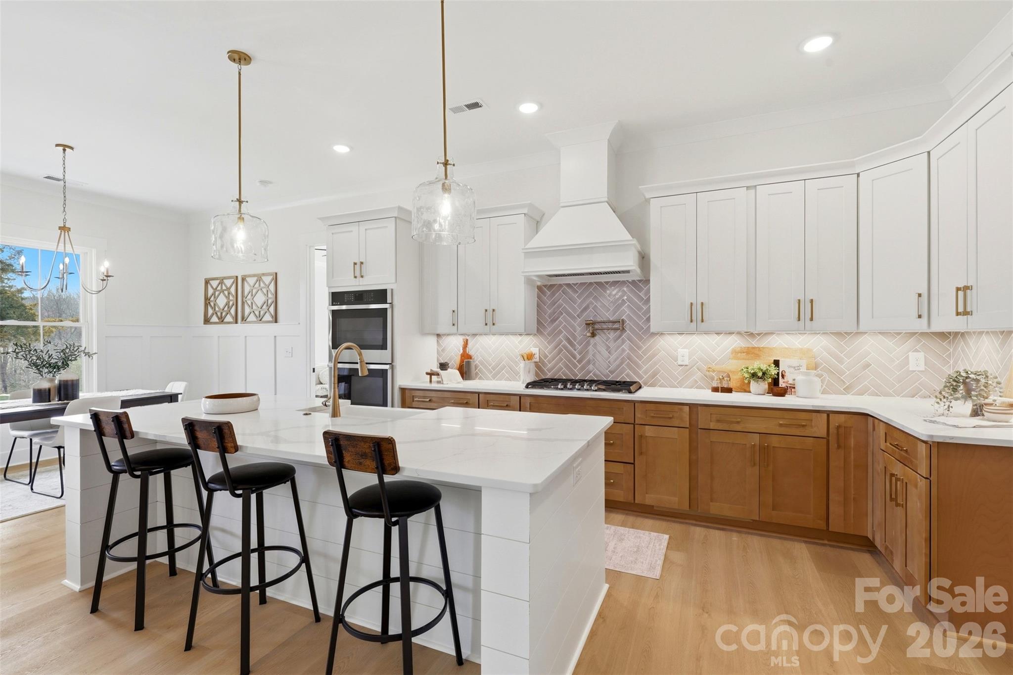 4748 Polk Ford Road Stanfield, NC 28163 - Photo 14 of 47 a kitchen with stainless steel appliances granite countertop a sink a stove a dining table and chairs