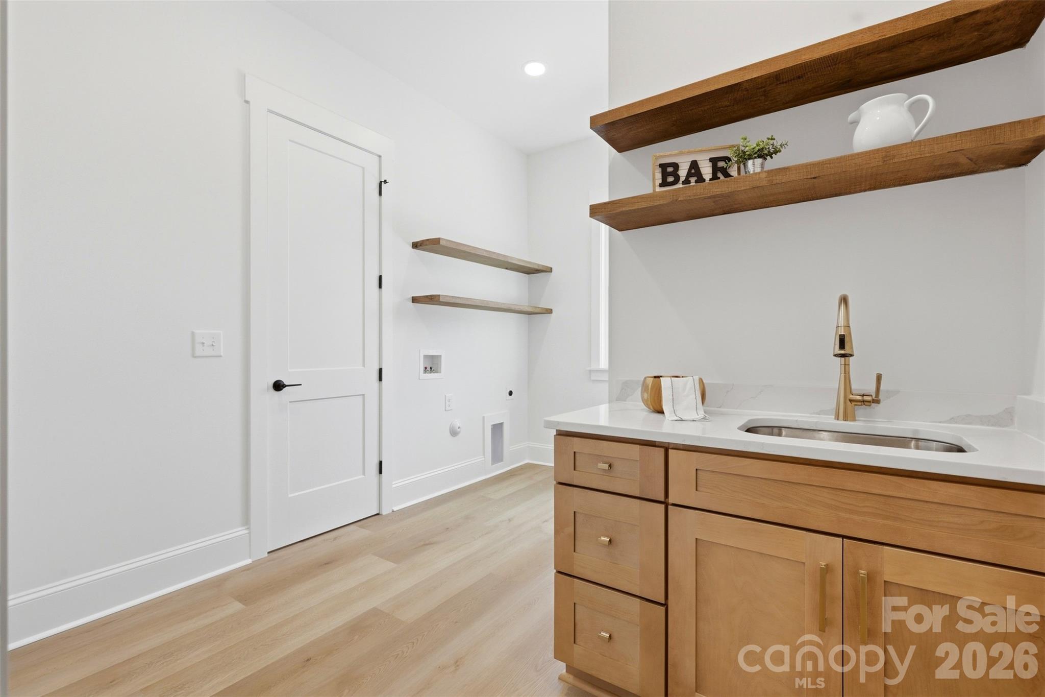 4748 Polk Ford Road Stanfield, NC 28163 - Photo 31 of 47 a kitchen with a sink and cabinets