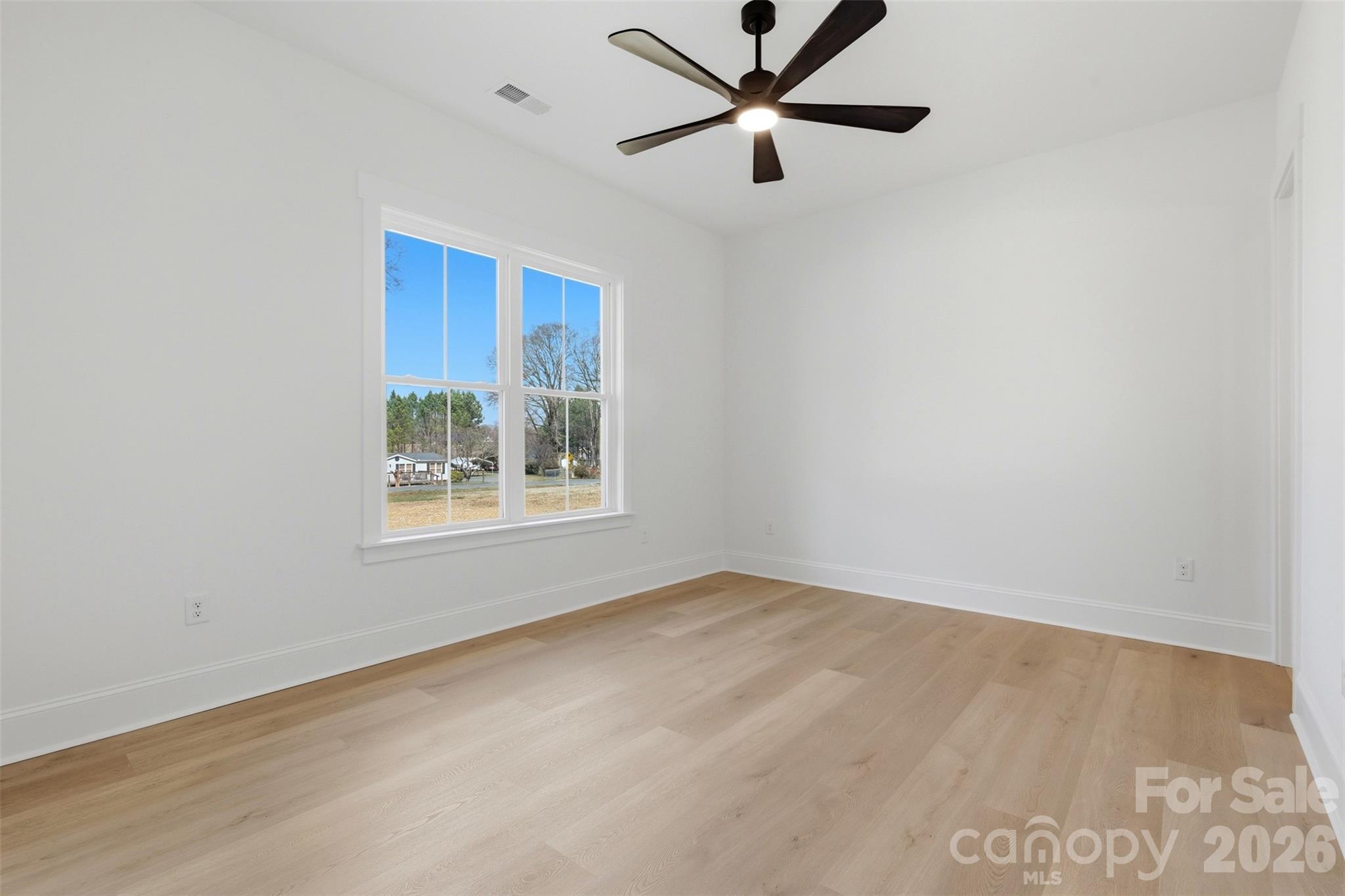 4748 Polk Ford Road Stanfield, NC 28163 - Photo 32 of 47 an empty room with a window and a fan