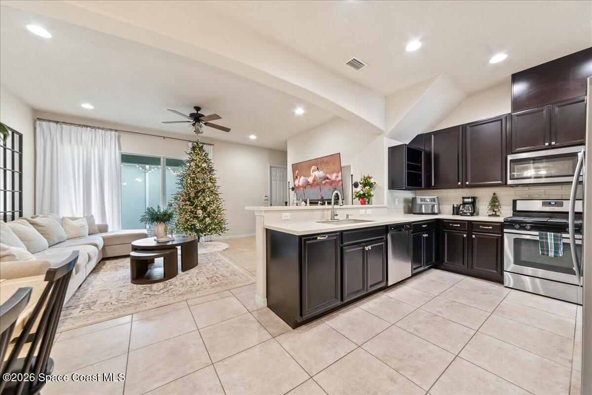 4938 Sprint Circle Rockledge, FL 32955 - Photo 12 of 37 a kitchen with stainless steel appliances kitchen island granite countertop a sink and cabinets