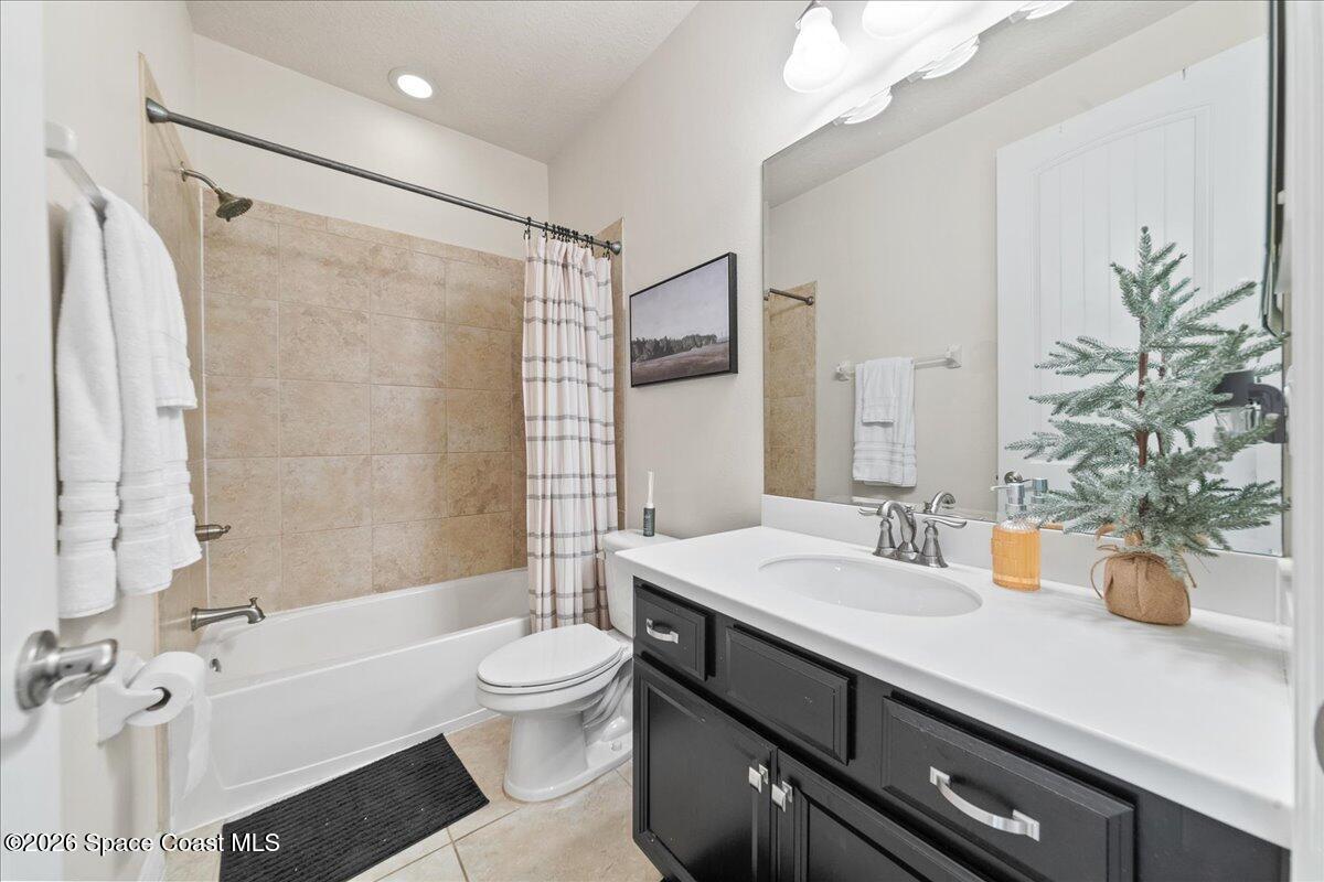 4938 Sprint Circle Rockledge, FL 32955 - Photo 22 of 37 a bathroom with a sink a toilet and shower