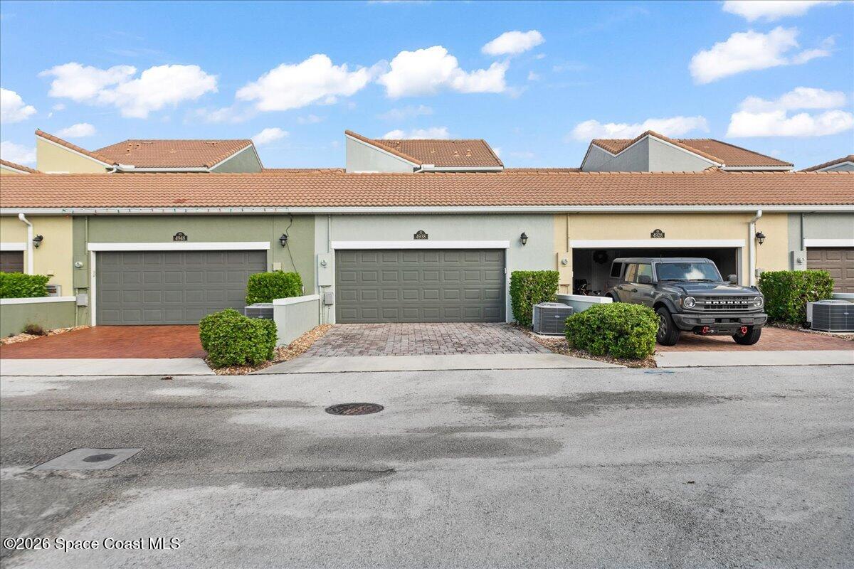 4938 Sprint Circle Rockledge, FL 32955 - Photo 25 of 37 front view of a house with a yard and potted plants