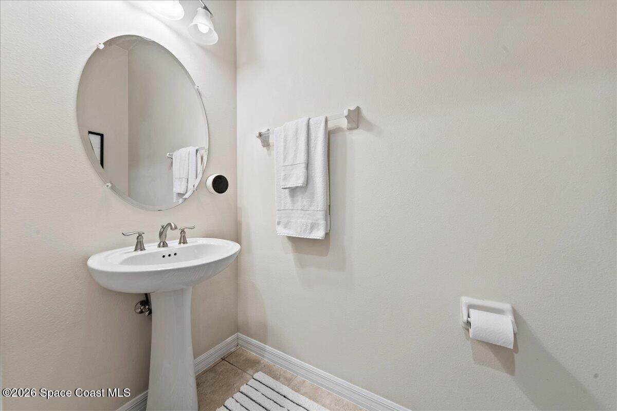 4938 Sprint Circle Rockledge, FL 32955 - Photo 9 of 37 a bathroom with a sink and a mirror