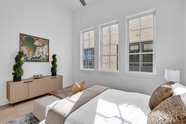 a bedroom with a bed and a window