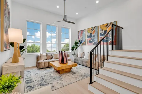 a living room with furniture and a potted plant