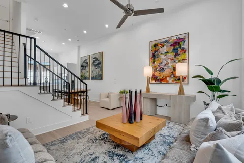 a view of living room with furniture and wooden floor