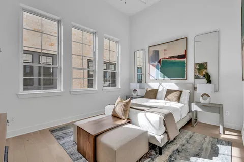 a bedroom with bed and a flat tv screen