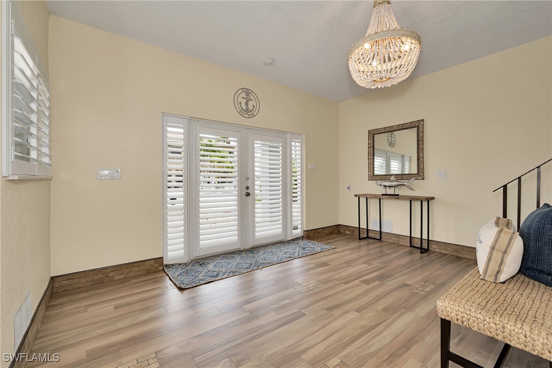 189 Gulfview Drive Islamorada, FL 33036 - Photo 17 of 49 a view of an empty room with a window and wooden floor