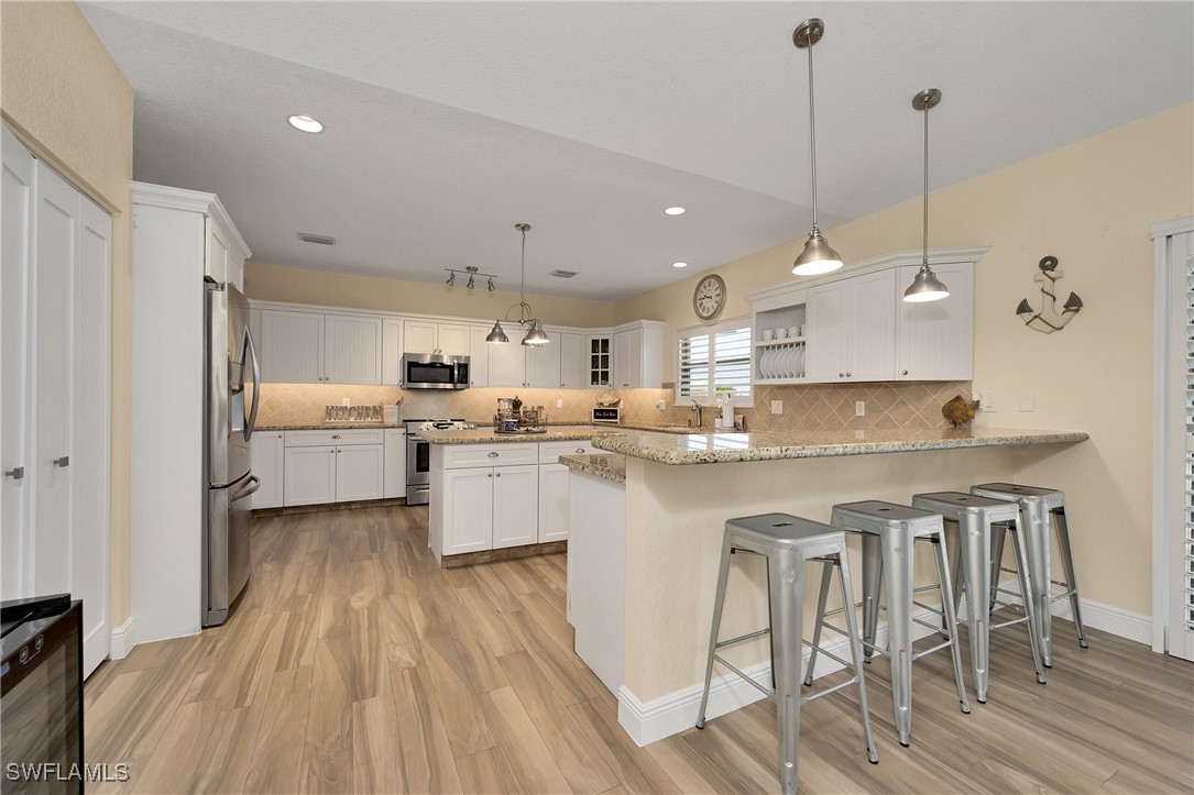 189 Gulfview Drive Islamorada, FL 33036 - Photo 20 of 49 a kitchen with white cabinets and stainless steel appliances