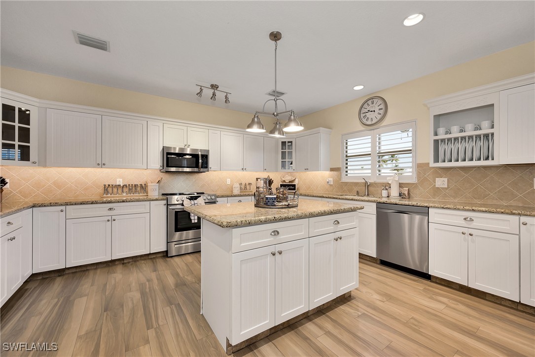 189 Gulfview Drive Islamorada, FL 33036 - Photo 21 of 49 a kitchen with granite countertop a sink cabinets and wooden floor