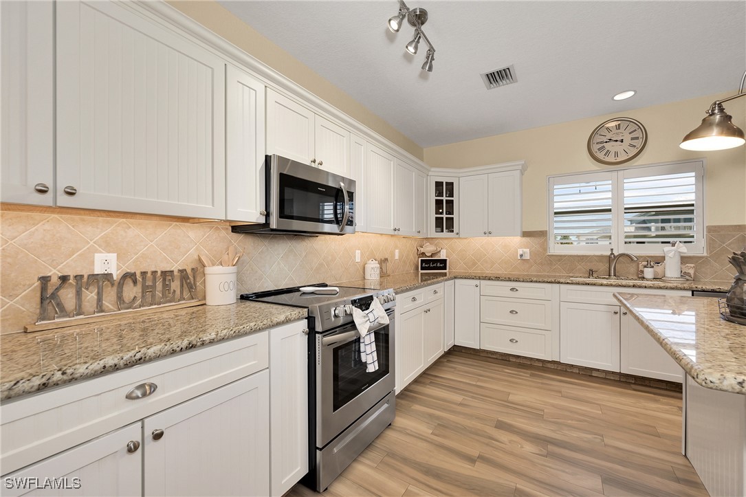 189 Gulfview Drive Islamorada, FL 33036 - Photo 22 of 49 a kitchen with granite countertop cabinets stainless steel appliances a sink and a window