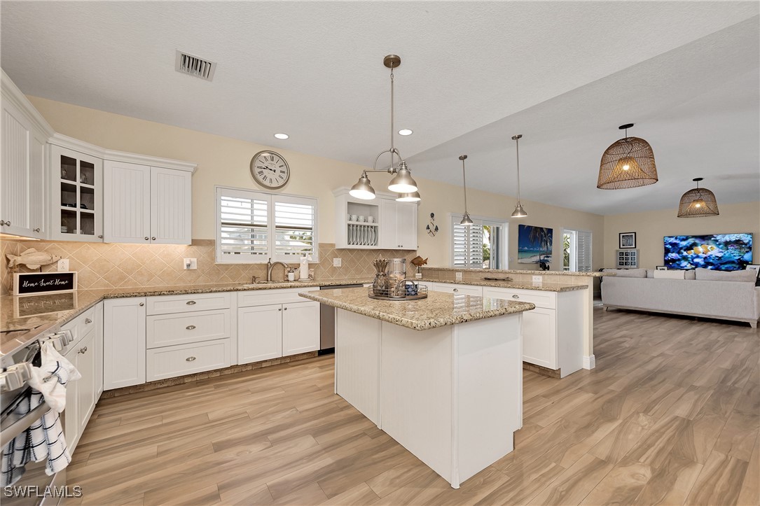 189 Gulfview Drive Islamorada, FL 33036 - Photo 23 of 49 a large kitchen with kitchen island a sink and a stove top oven
