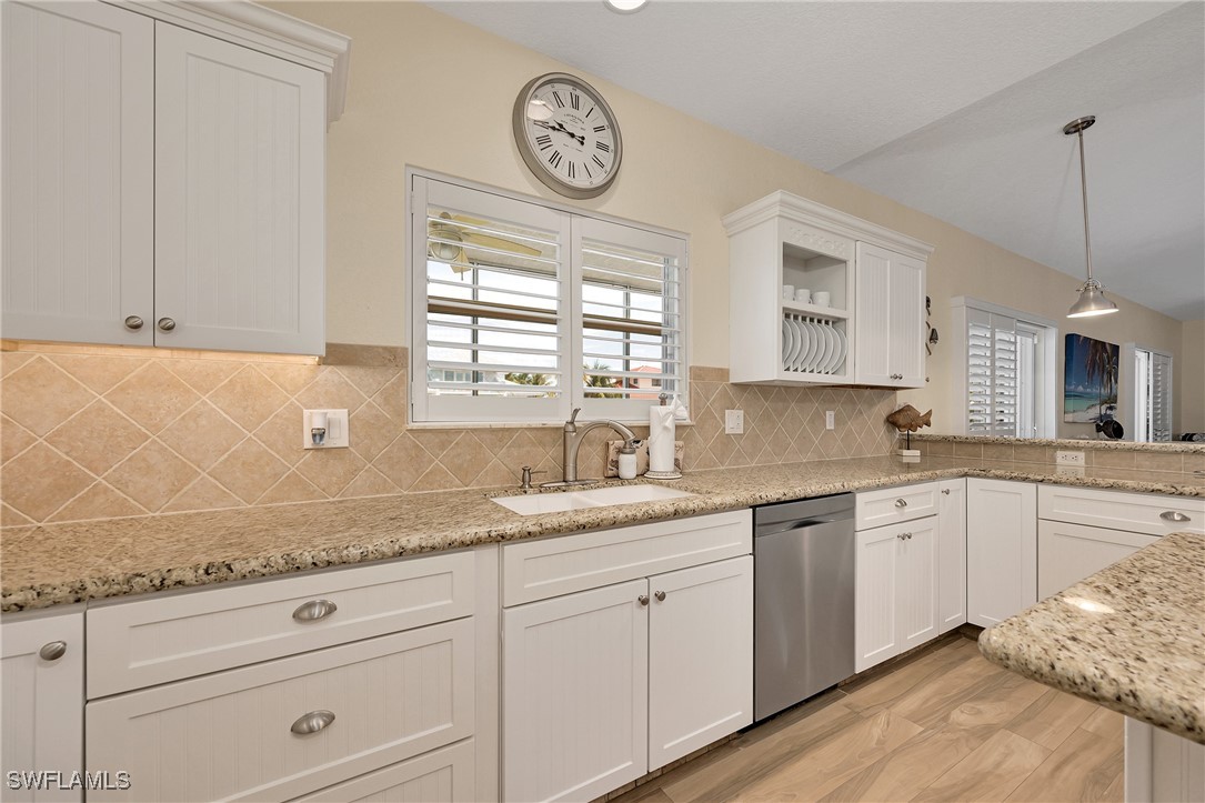 189 Gulfview Drive Islamorada, FL 33036 - Photo 24 of 49 a kitchen with granite countertop white cabinets and white stainless steel appliances