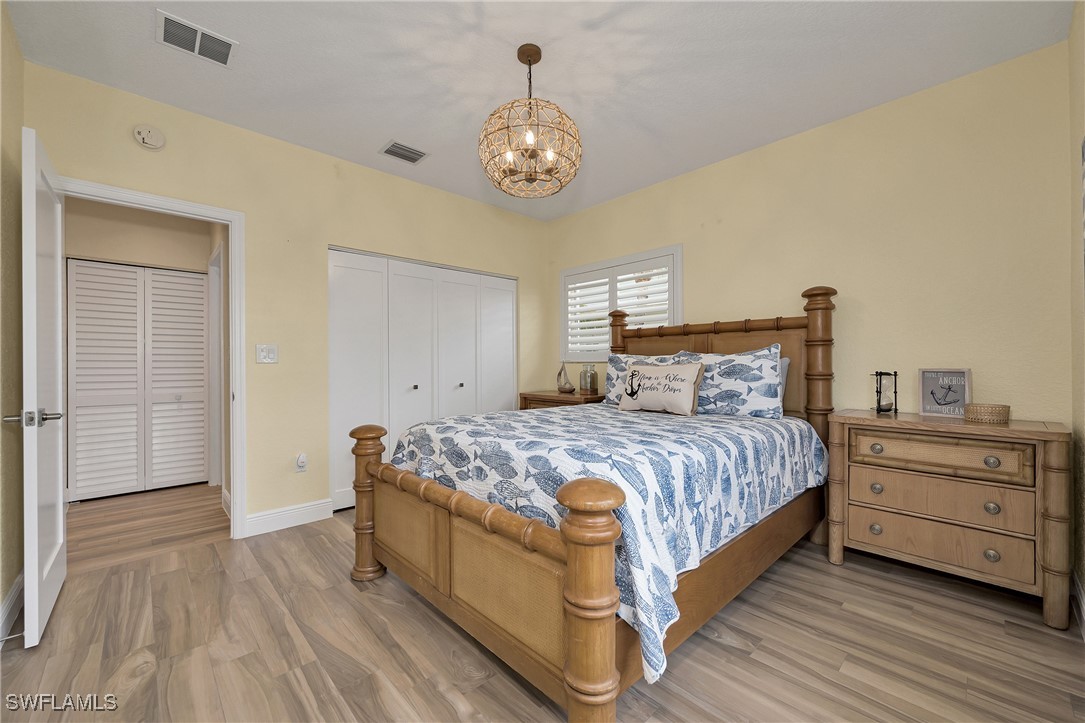 189 Gulfview Drive Islamorada, FL 33036 - Photo 29 of 49 a bedroom with a bed and a chandelier