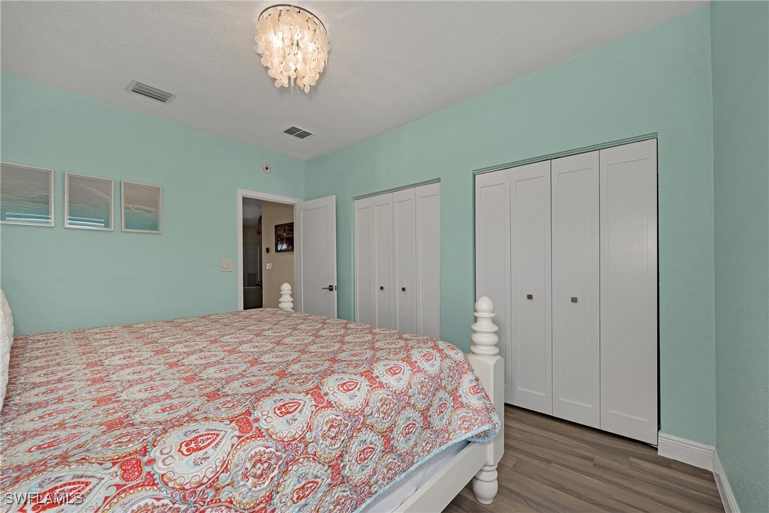 189 Gulfview Drive Islamorada, FL 33036 - Photo 32 of 49 a bedroom with a bed and wooden floor