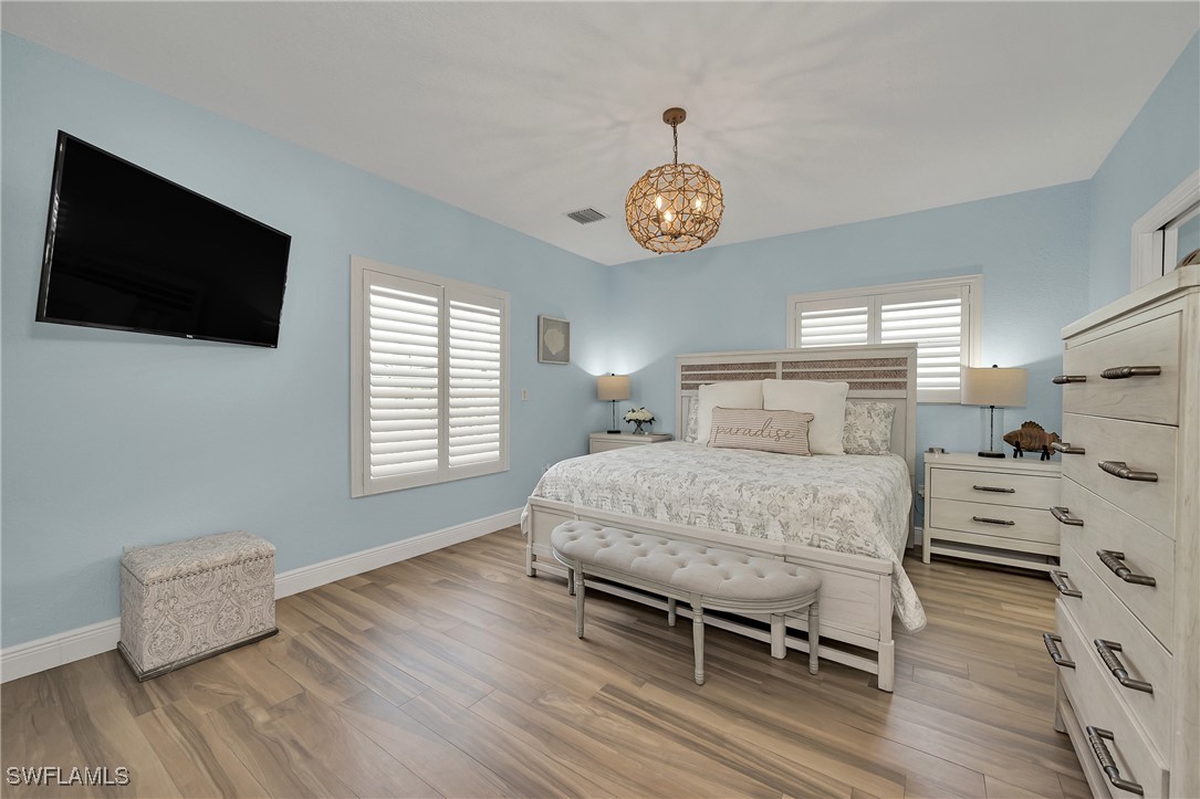 189 Gulfview Drive Islamorada, FL 33036 - Photo 33 of 49 a bedroom with a bed and a flat tv screen on the dresser